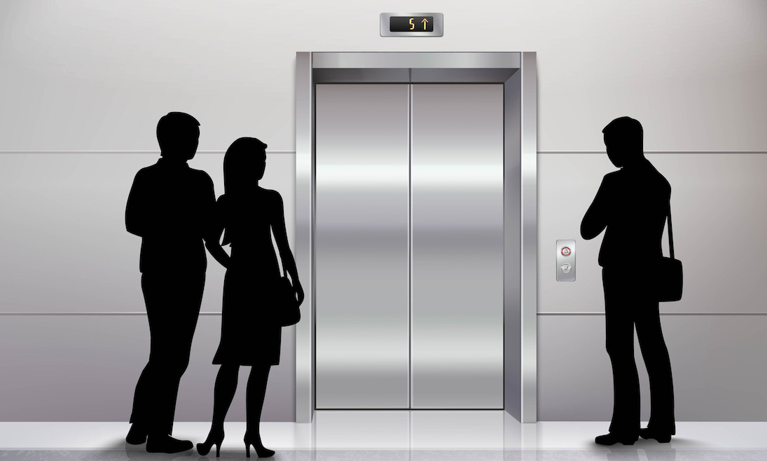 Three male and female people standing in front of modern elevator