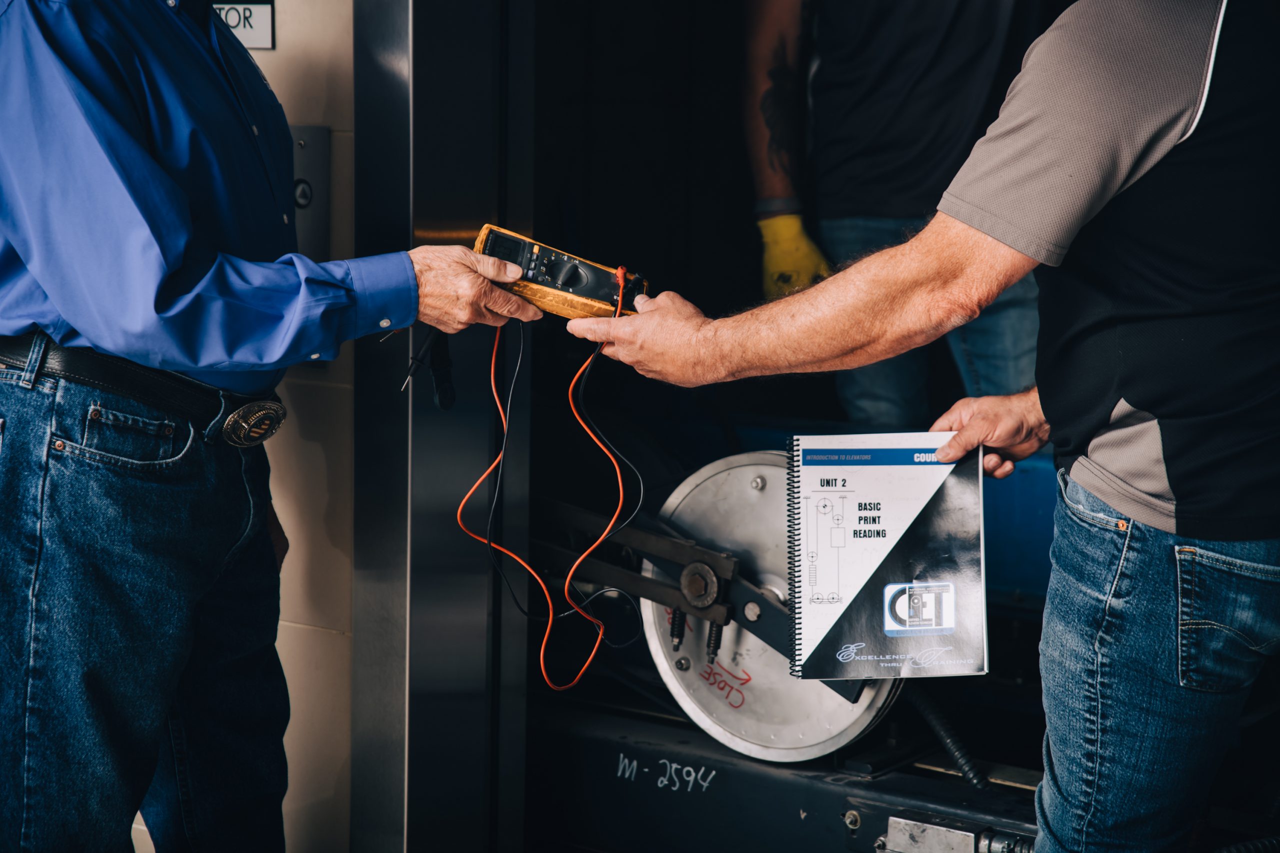 PEAK employee performing elevator maintenance