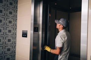 PEAK employee performing elevator maintenance